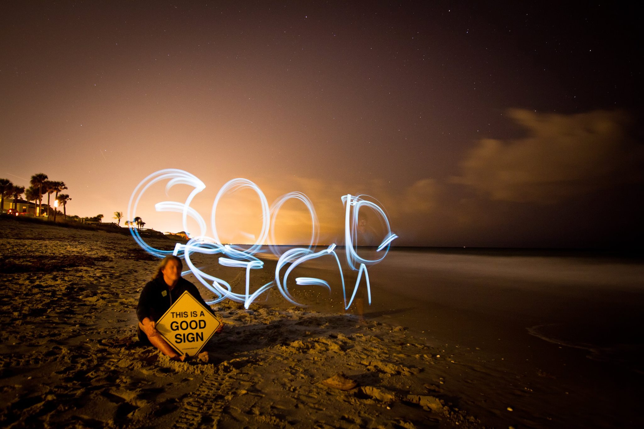 Early Good Sign light painting on a beach at night