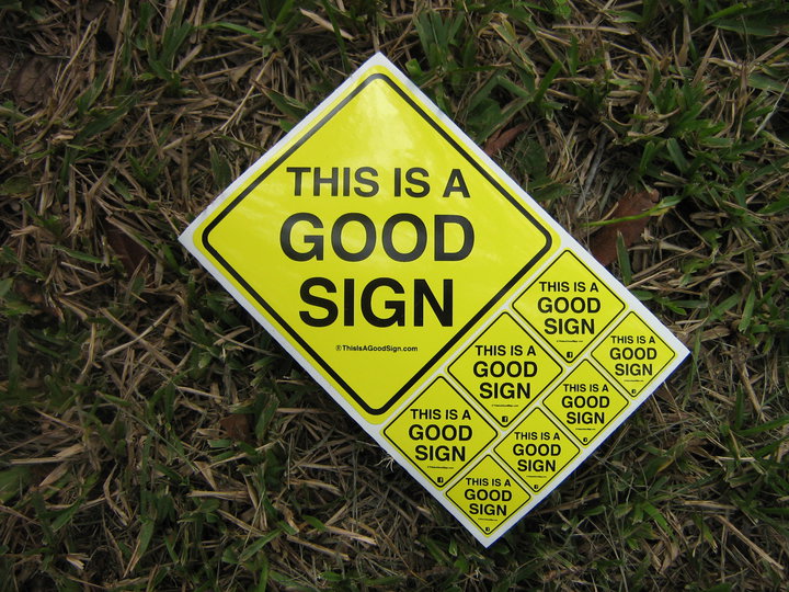 A sheet of early Good Sign stickers photographed on grass